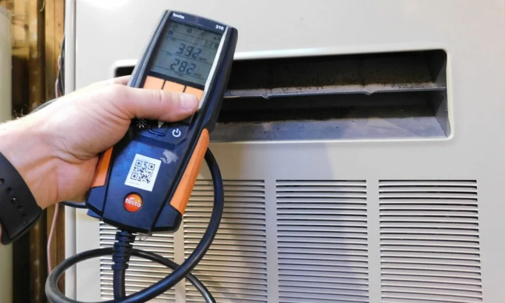 A technician checking the furnace CO output