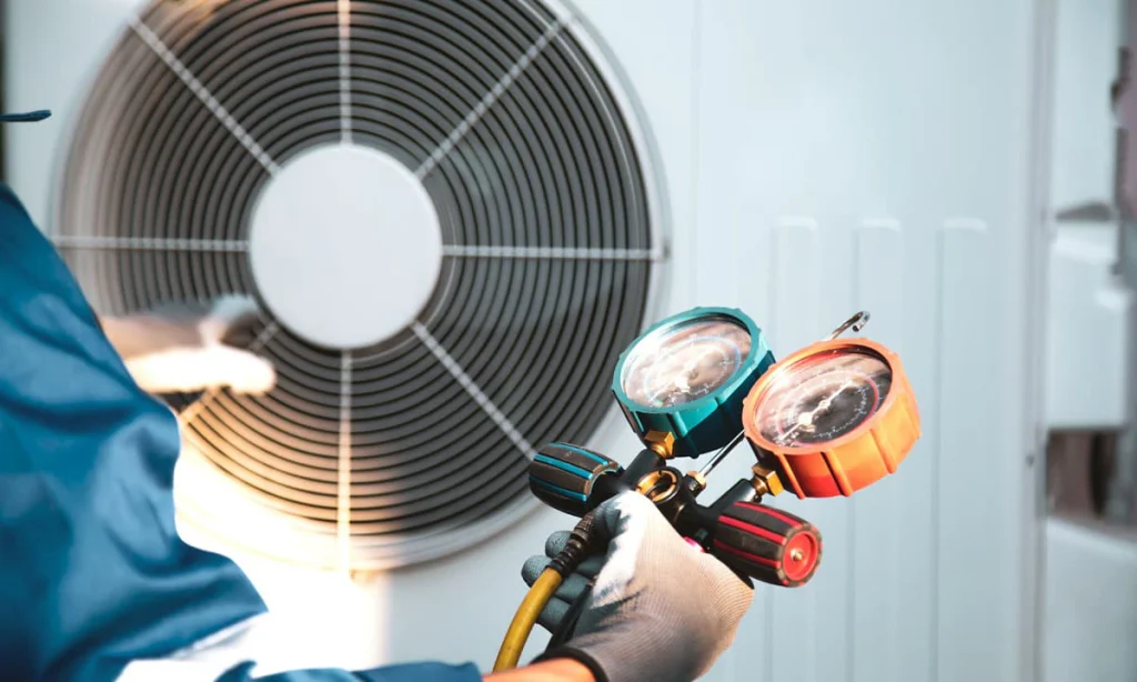 A technician inspecting the charge of an air conditioner unit