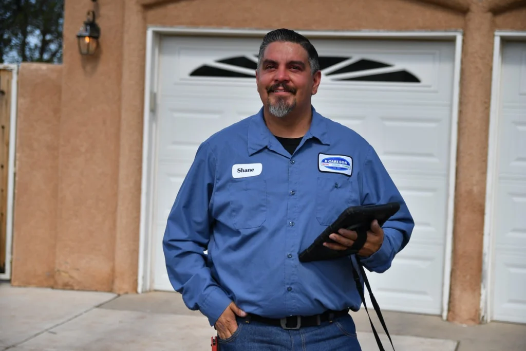 Professional HVAC technician with digital tablet in Albuquerque, NM