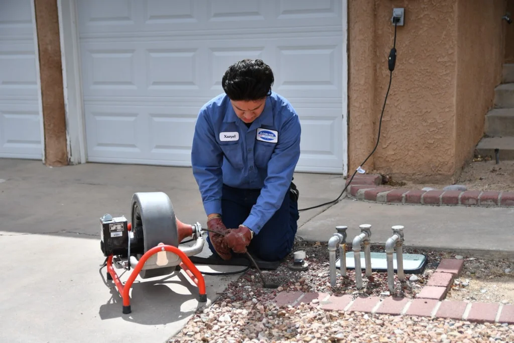Drain-clearing equipment set up on a residential drain line in Albuquerque, NM