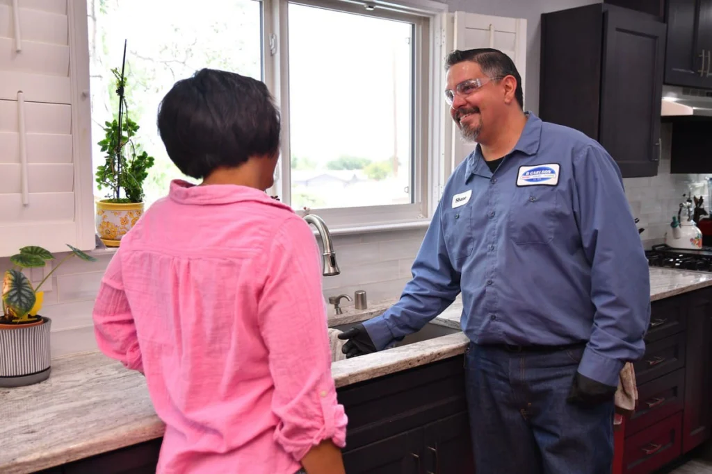 Plumber reviewing fixture options with a customer at an Albuquerque home