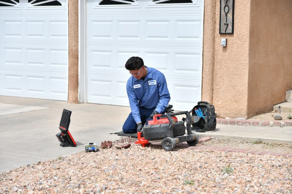 Professional technician inspecting a residential driveway in Albuquerque, NM