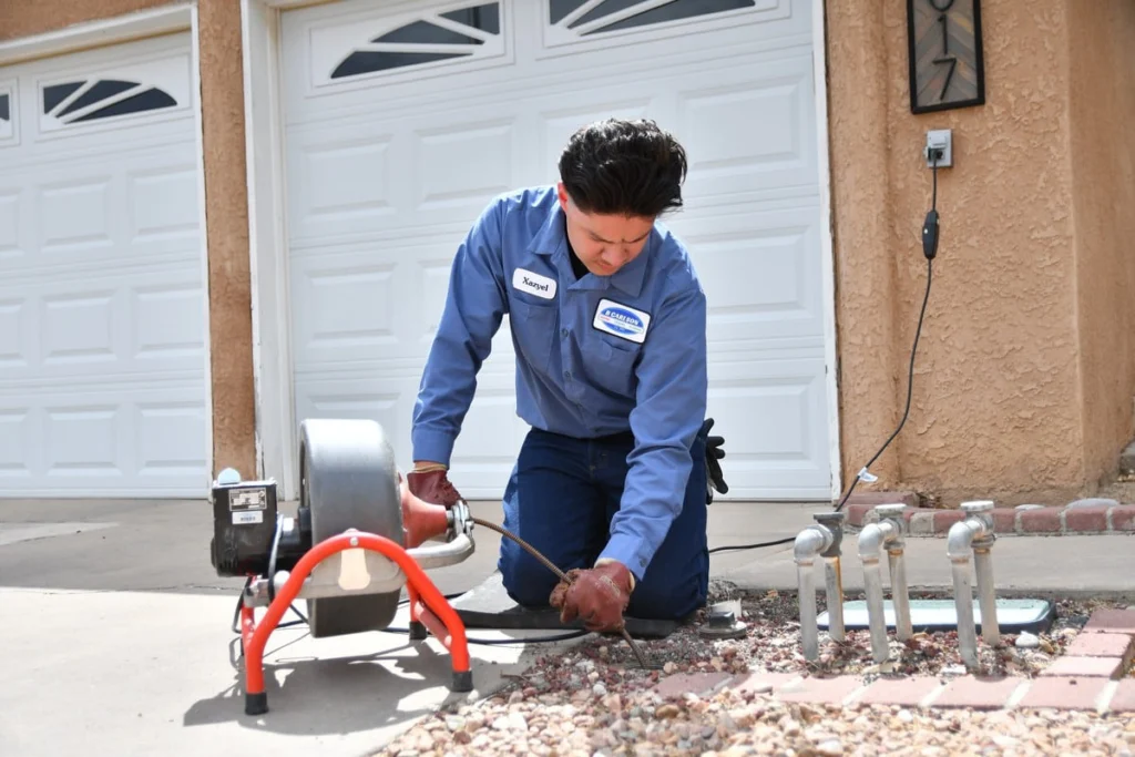 Professional technician performing residential drain maintenance in Albuquerque, NM