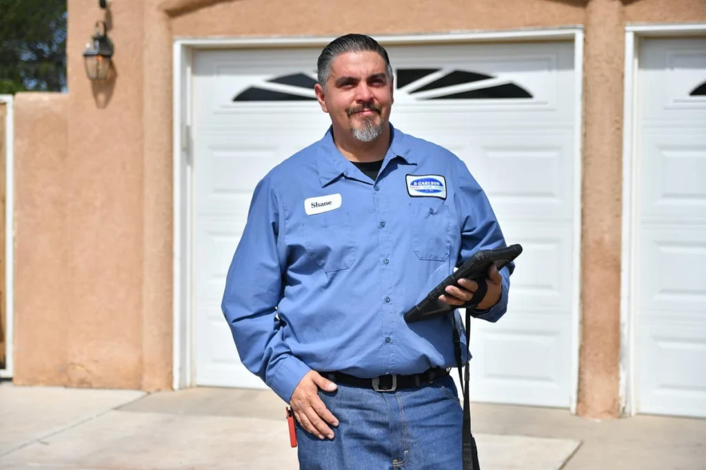 B. Carlson technician reviewing indoor comfort options on a tablet at an Albuquerque home