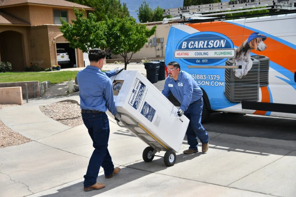 Professional technicians delivering water heater equipment in Albuquerque, NM