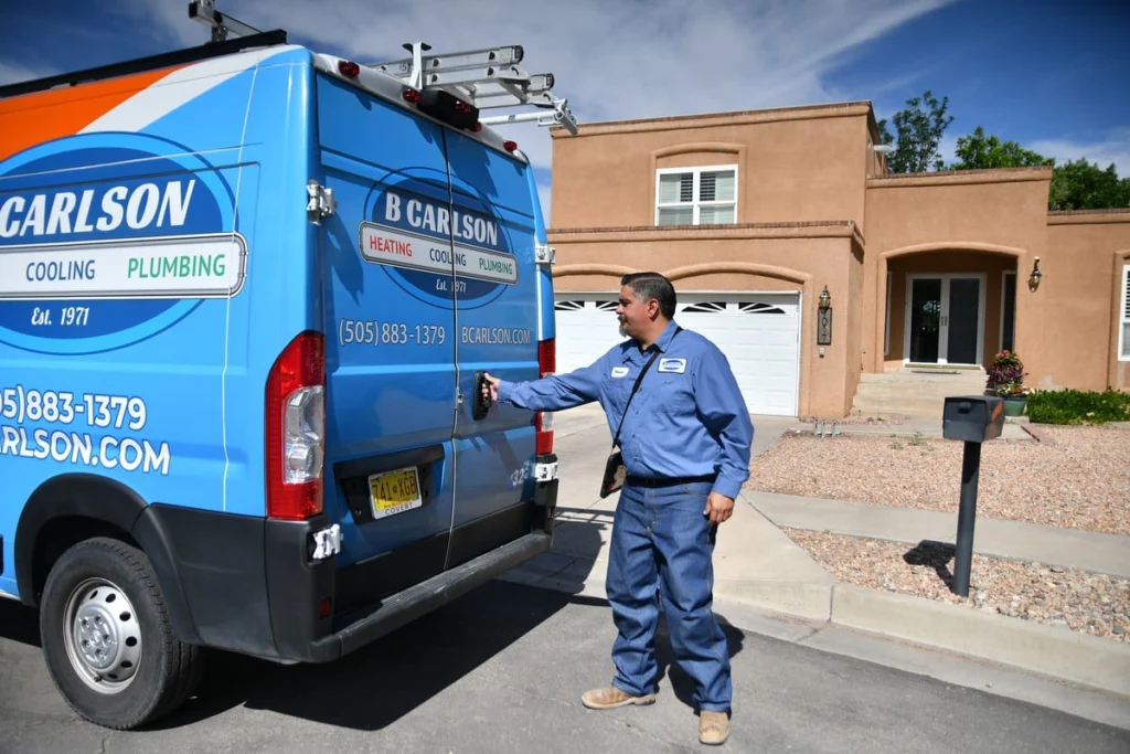 Service technician at residential home with van in Albuquerque, NM