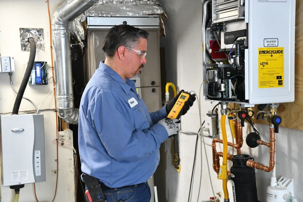 Technician inspecting tankless water heater in Albuquerque, NM