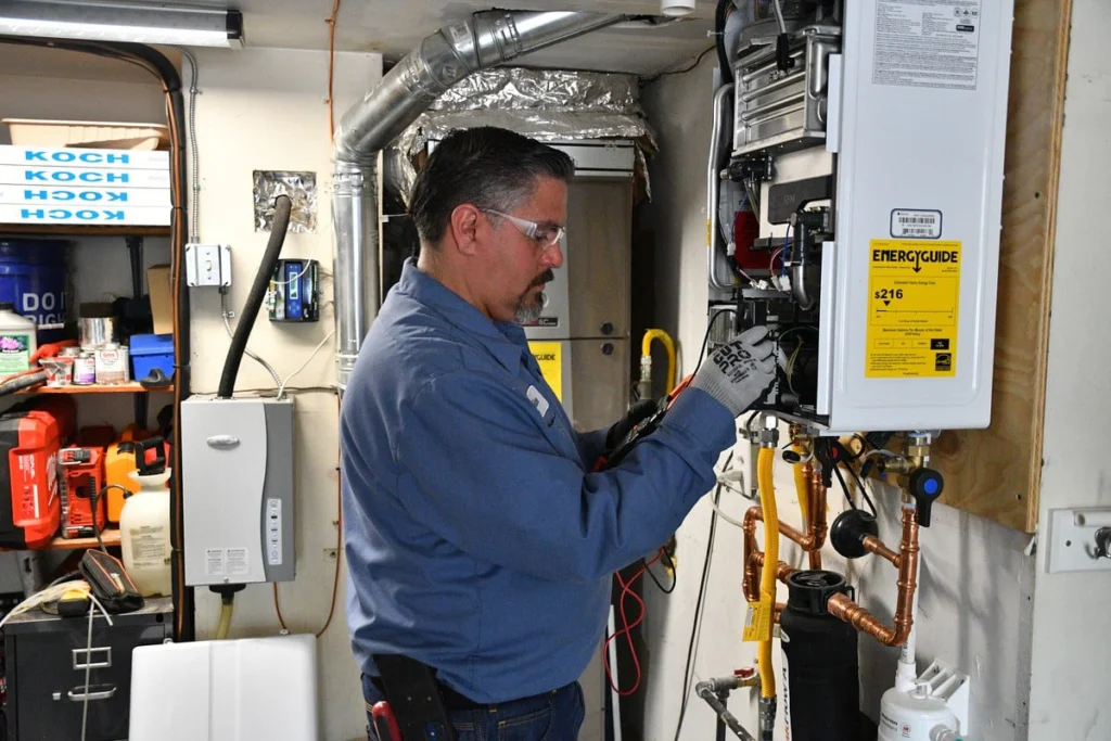 Technician installing and testing a tankless water heater in Albuquerque, NM