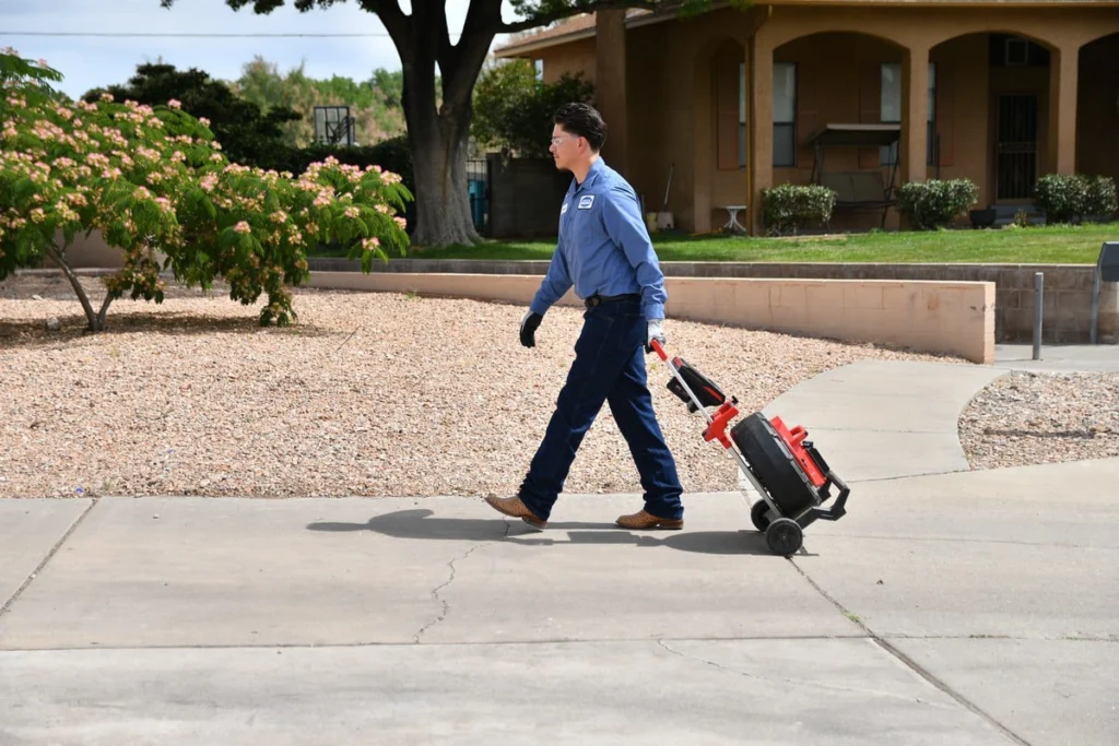 Technician transporting inspection camera equipment in Albuquerque, NM