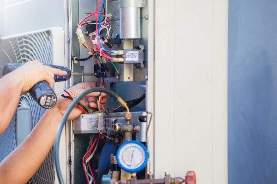 An HVAC technician installing an A/C unit