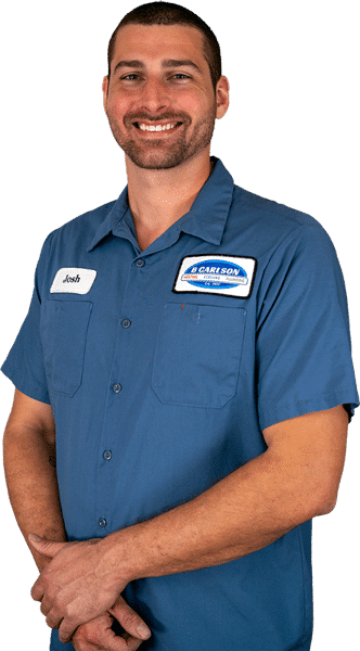 A smiling B Carlson HVAC technician
