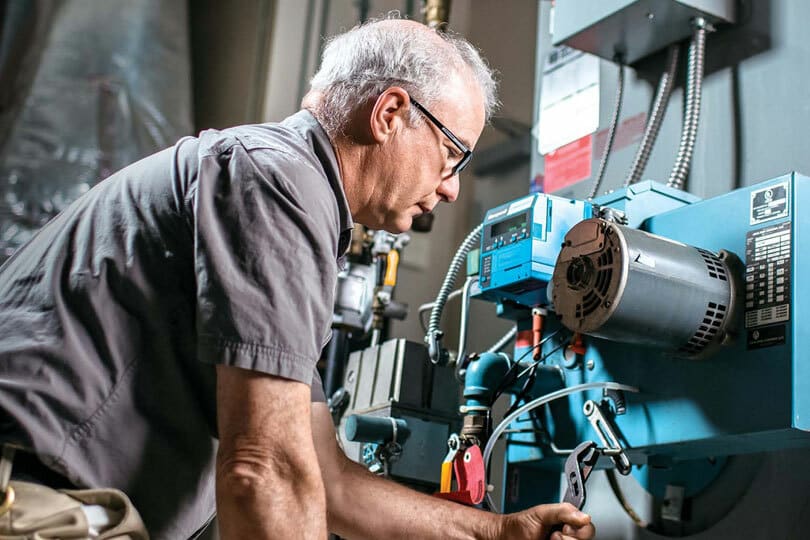 A tech working on a boiler