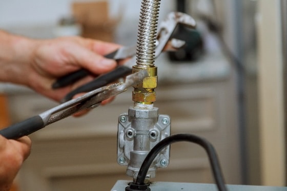 A plumber fixing a gas line