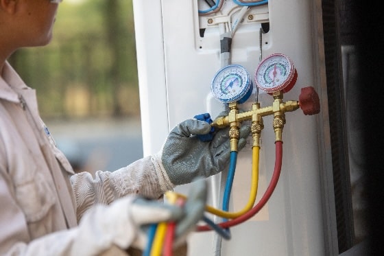 A technician reading HVAC gauges