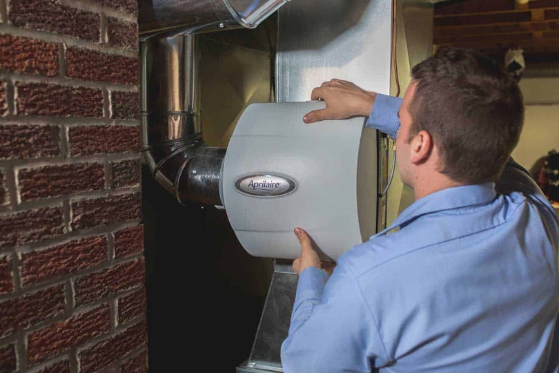 A tech working on a whole house humidifier