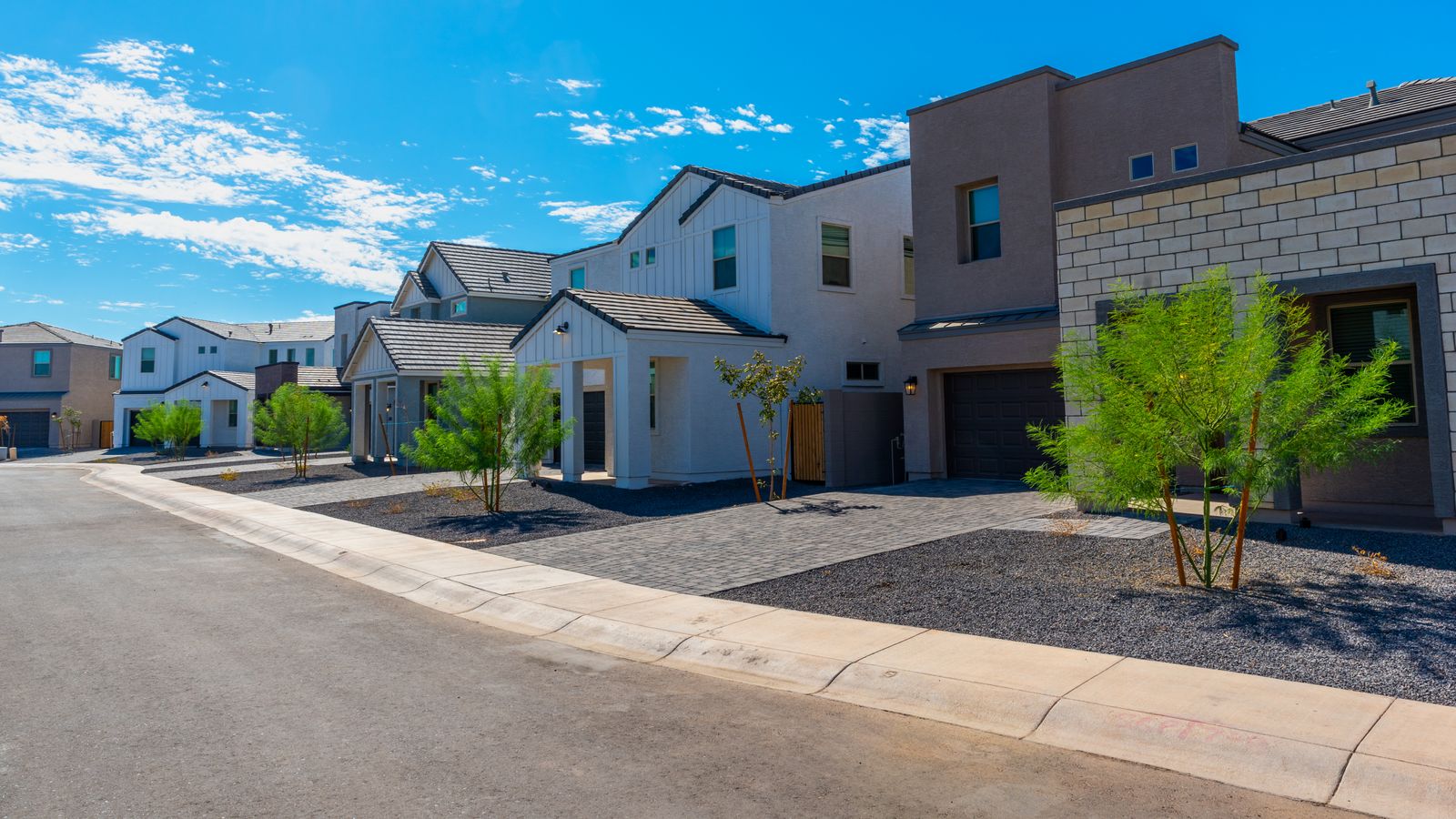 A street lined with homes in a desert community.