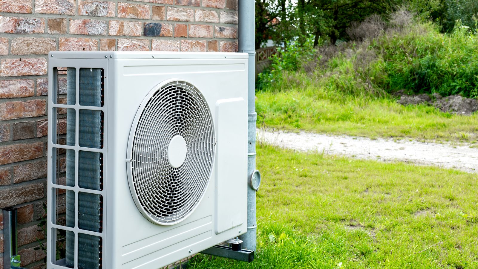 A heat pump compressor outside a home.