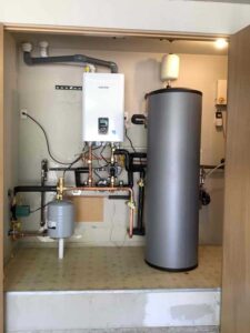 Here you can see the newly installed Navien high-efficiency boiler alongside the 64.5-gallon indirect water heater. The system is fully re-piped and ready to deliver consistent heating and domestic hot water.