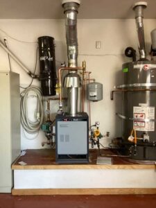 Completed boiler installation with venting, expansion tank, and piping in Los Ranchos de Albuquerque home