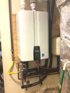 Navien tankless water heater installation in Albuquerque with completed plumbing connections