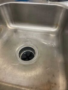 A view from the sink down to the recently installed garbage disposal unit