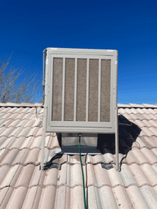 New evaporative cooler installed on tile roof in Albuquerque NM