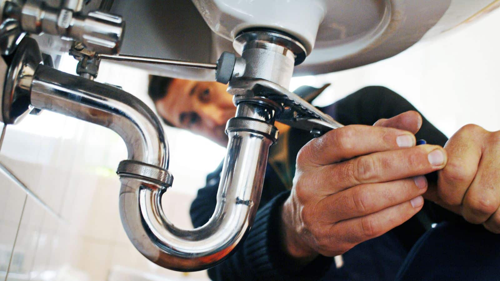 Up close of a p-trap under a bathroom sink