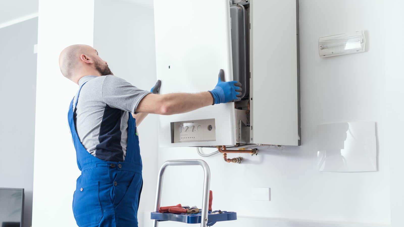 A plumber inspecting a tankless water heater