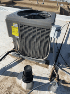 New air conditioning condenser installed on rooftop in Santa Fe NM