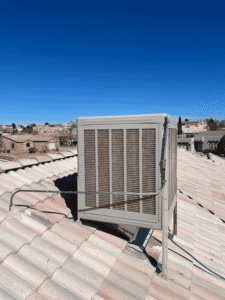 Rooftop evaporative cooler installation overlooking Albuquerque neighborhood