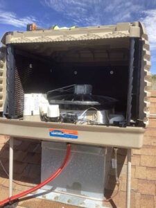 Interior components of Breezair evaporative cooler showing fan and system setup