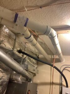 Tankless water heater exhaust and vent piping installed to meet Albuquerque code requirements