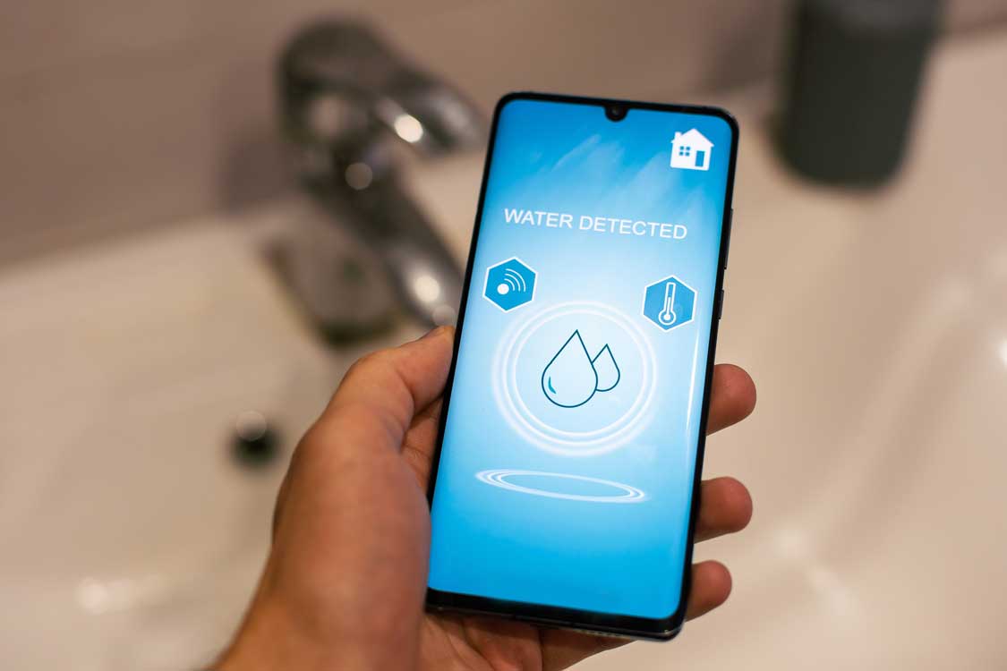 A phone app that pairs with a water leak detector sensor showing an active leak