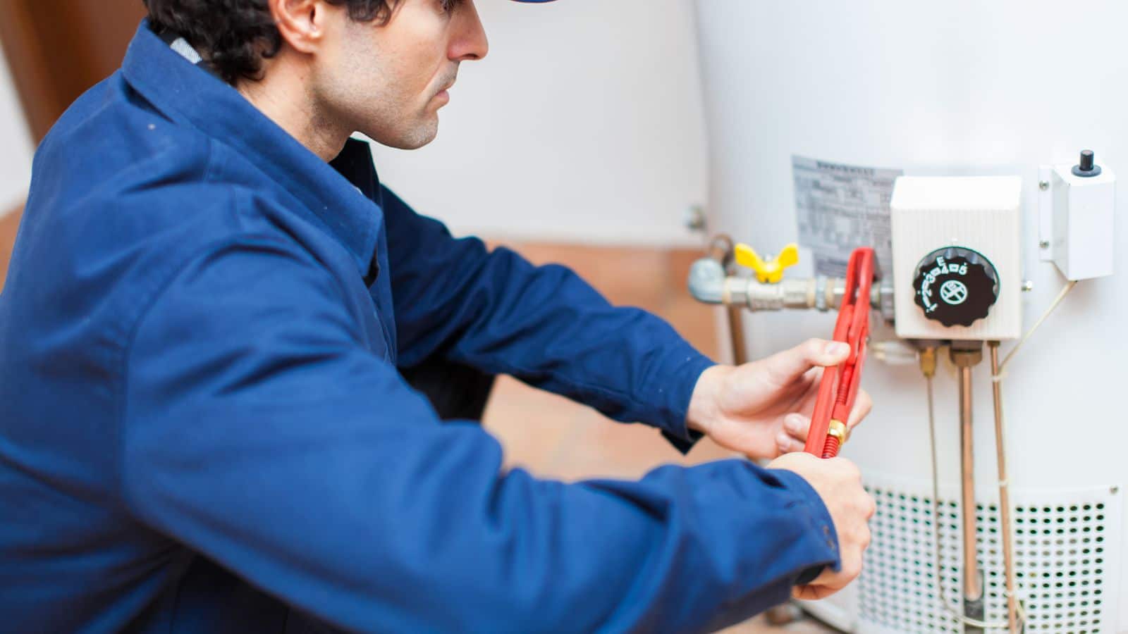 Plumber adjusting water heater valves